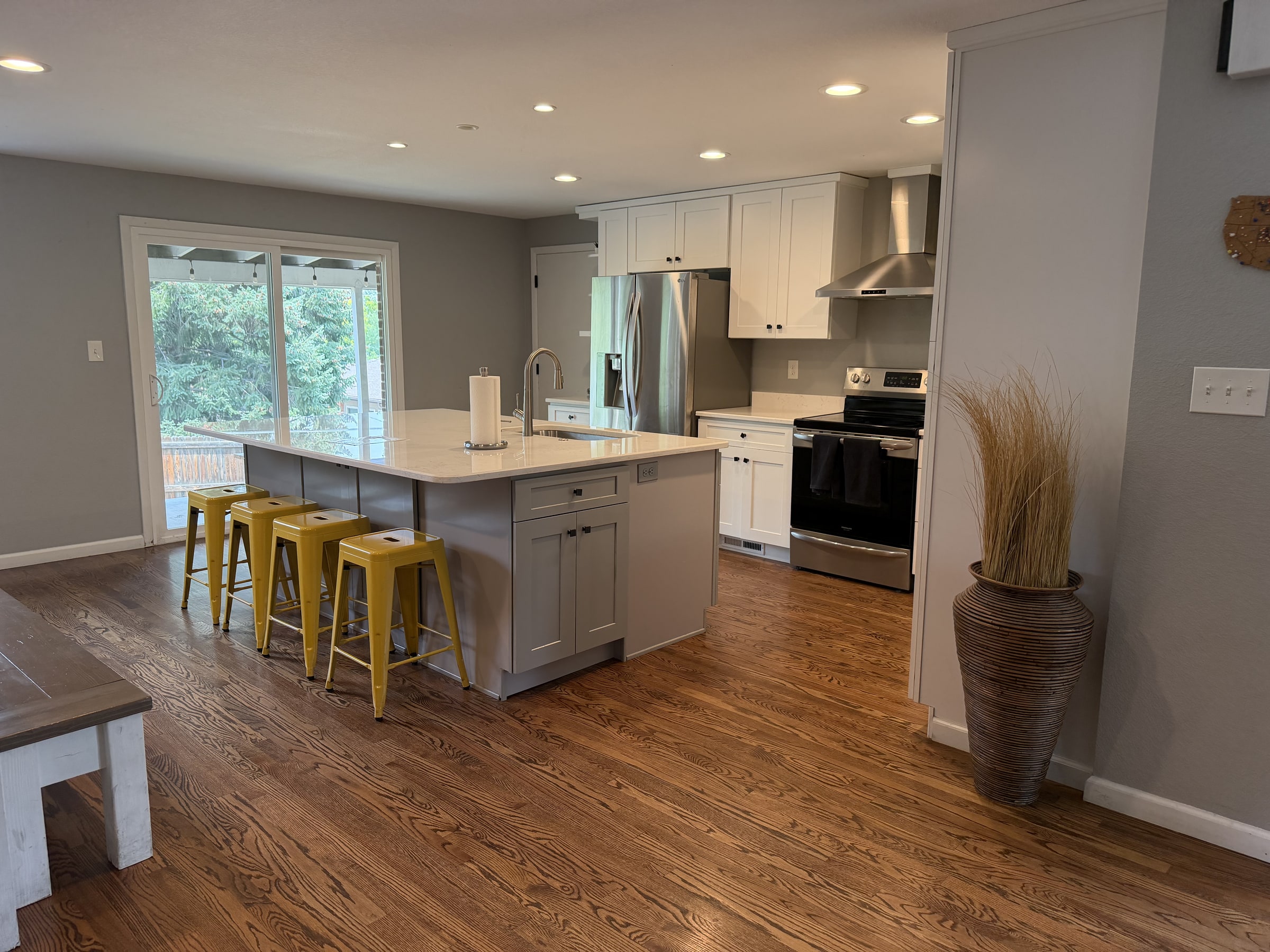 Bright kitchen island with polished floors and clean white cabinetry